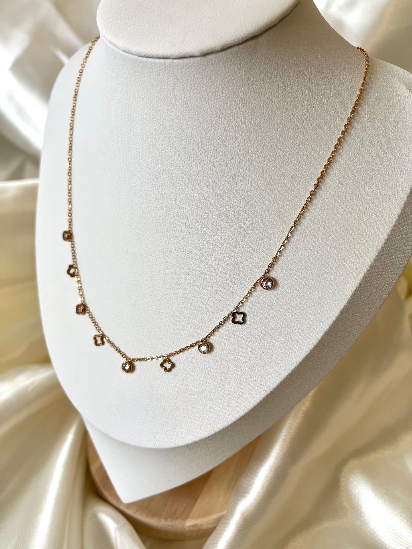 Collier doré pendentifs strass et trèfles